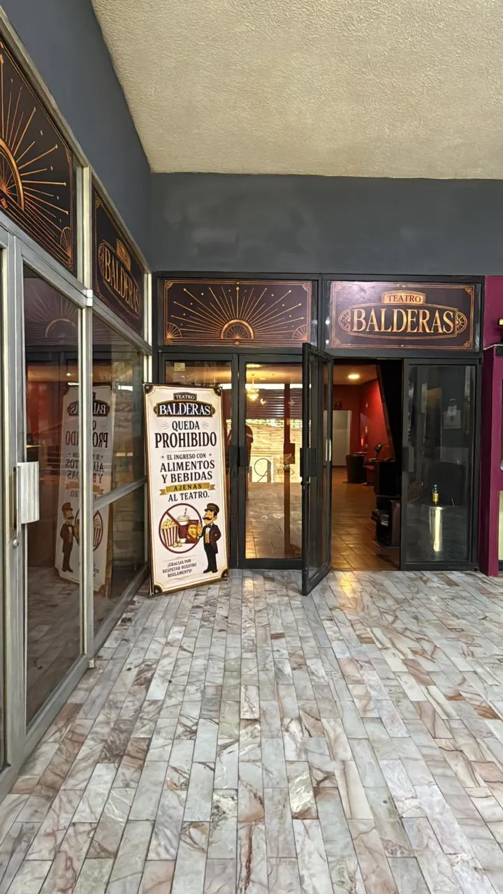 Puertas de entrada del Teatro Balderas con la marquesina y el letrero iluminado del recinto.